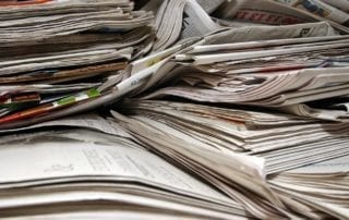 Photo of a stack of newspapers.