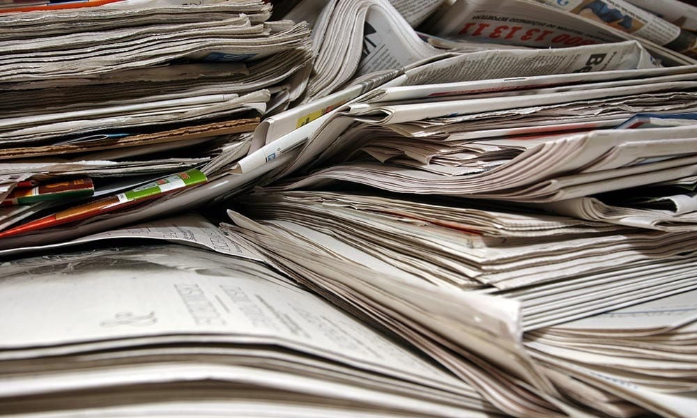 Photo of a stack of newspapers.