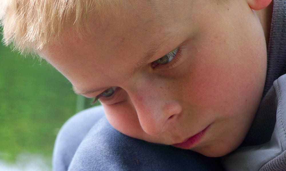 Photo of sad little boy.