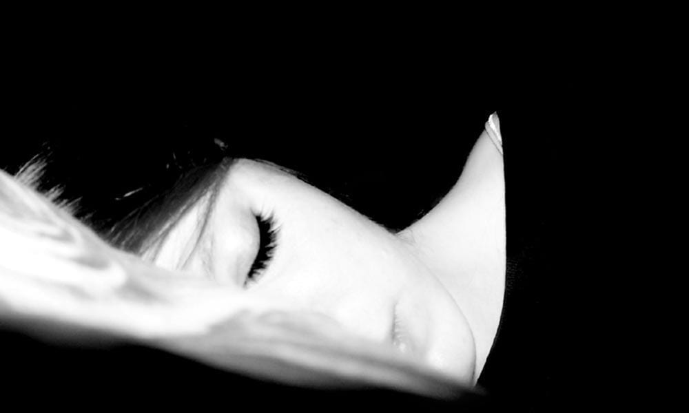 Photo of woman's peaceful face as she sleeps.